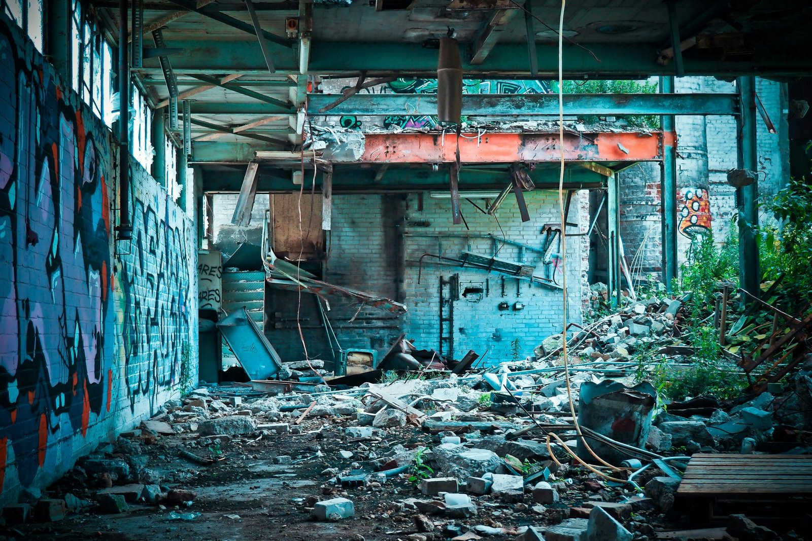 An urban exploration scene featuring graffiti and ruins in a dilapidated warehouse.
